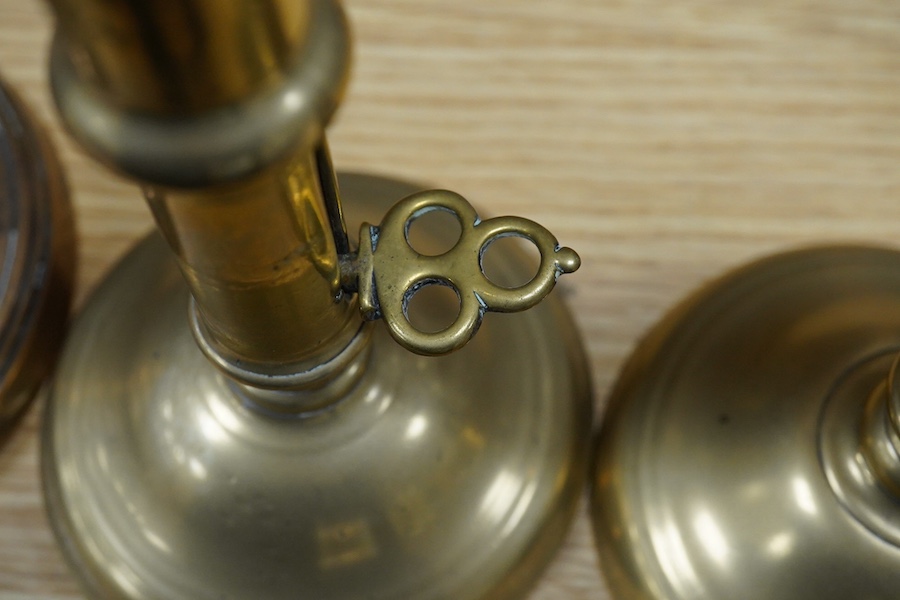 Two pairs of candlesticks to include 18th century brass ejector examples, 37cm wide. Condition - good